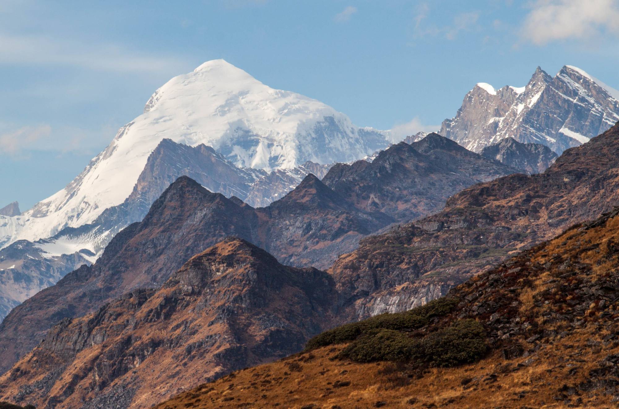 Jomolhari's snow-covered summit above brown autumn ridges